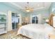 Main bedroom with king-size bed, walk-in closet, and sliding glass doors to patio at 70 Marker Rd, Rotonda West, FL 33947