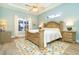 Large main bedroom with king-size bed, ceiling fan, and access to the patio at 70 Marker Rd, Rotonda West, FL 33947