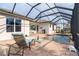 Relaxing pool and patio area with covered lanai at 70 Marker Rd, Rotonda West, FL 33947