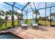 Relaxing patio with lounge chairs near a screened pool at 70 Marker Rd, Rotonda West, FL 33947