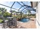 Screened-in pool and patio area with seating at 70 Marker Rd, Rotonda West, FL 33947