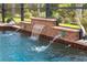 Close-up view of a pool's waterfall feature at 70 Marker Rd, Rotonda West, FL 33947