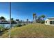 Spacious grassy backyard with water views and palm trees at 701 W Perry St, Englewood, FL 34223