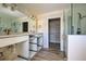 Double vanity bathroom with walk-in shower and shelving at 701 W Perry St, Englewood, FL 34223