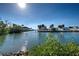 Peaceful canal view with lush greenery and neighboring houses at 701 W Perry St, Englewood, FL 34223