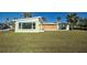 Light green house with boarded windows and yard at 701 W Perry St, Englewood, FL 34223