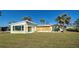 Ranch style home with large windows and a grassy yard at 701 W Perry St, Englewood, FL 34223