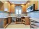 Unfinished kitchen with wood cabinets and mosaic backsplash at 701 W Perry St, Englewood, FL 34223