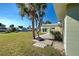 Relaxing patio area with palm trees and water views at 701 W Perry St, Englewood, FL 34223