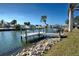 Private dock on a calm waterway with lush landscaping at 701 W Perry St, Englewood, FL 34223