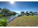 Peaceful waterfront view with lush vegetation at 701 W Perry St, Englewood, FL 34223