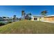 Backyard of the house showing a green lawn and canal at 701 W Perry St, Englewood, FL 34223