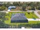 Aerial view of a home with a pool and solar panels, showcasing its large backyard at 7510 Kenway St, Englewood, FL 34224