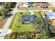 An aerial view of a single-Gathering home with a pool and a large grassy backyard at 7510 Kenway St, Englewood, FL 34224