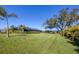 Expansive grassy backyard with mature trees and lush landscaping at 7510 Kenway St, Englewood, FL 34224