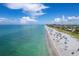 Aerial view of a pristine beach with turquoise water and people enjoying the day at 7510 Kenway St, Englewood, FL 34224