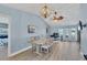 Dining room with a farmhouse table and view into the kitchen at 7510 Kenway St, Englewood, FL 34224