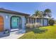 Front view of the home with teal door and walkway at 7510 Kenway St, Englewood, FL 34224