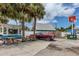 Charming street view with nearby establishments and beautiful, mature palm trees at 7510 Kenway St, Englewood, FL 34224