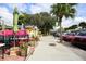 Outdoor seating area with colorful umbrellas and vibrant plants at 7510 Kenway St, Englewood, FL 34224