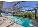 Inviting swimming pool with screened enclosure at 7510 Kenway St, Englewood, FL 34224