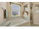 Bathroom with a garden tub, shower, and window at 80 Long Meadow Ln, Rotonda West, FL 33947