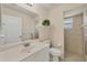 Small bathroom with toilet, sink, and shower at 80 Long Meadow Ln, Rotonda West, FL 33947