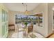 Breakfast nook with glass table and view of the pool and backyard at 80 Long Meadow Ln, Rotonda West, FL 33947