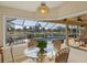 Breakfast nook features a glass table, wicker chairs, and a pool view at 80 Long Meadow Ln, Rotonda West, FL 33947