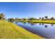 Tranquil canal-front view with lush landscaping and homes visible in the background at 80 Long Meadow Ln, Rotonda West, FL 33947