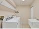 Laundry room with washer, dryer, and utility sink at 80 Long Meadow Ln, Rotonda West, FL 33947