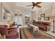 Living room with leather sofas and a view into the dining area at 80 Long Meadow Ln, Rotonda West, FL 33947