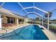 Relax by the pool; this screened enclosure provides shade and comfort at 80 Long Meadow Ln, Rotonda West, FL 33947