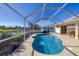 Inviting kidney-shaped pool with screened enclosure and tranquil water views at 80 Long Meadow Ln, Rotonda West, FL 33947