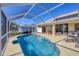 Screened pool and patio with seating area, perfect for outdoor entertaining at 80 Long Meadow Ln, Rotonda West, FL 33947