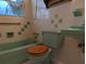 Bathroom with light green fixtures and tiled walls at 839 E 4Th St, Englewood, FL 34223