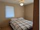 Bedroom with plaid bedding and ceiling fan at 839 E 4Th St, Englewood, FL 34223