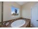 Bathroom with garden tub and a stained-glass window at 8626 Agate St, Port Charlotte, FL 33981