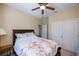 Bright bedroom with a floral comforter and double door closet at 8626 Agate St, Port Charlotte, FL 33981