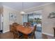 Bright dining room with wooden table and chairs, plus sliding glass doors to the pool area at 8626 Agate St, Port Charlotte, FL 33981