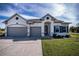 Two-story house with gray siding, two-car garage, and landscaped lawn at 8626 Agate St, Port Charlotte, FL 33981