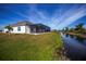 Back of house with screened lanai overlooking a canal at 8626 Agate St, Port Charlotte, FL 33981