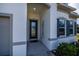 Inviting house entrance with a dark gray door and gray shutters at 8626 Agate St, Port Charlotte, FL 33981