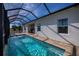 Screened-in pool with a spacious patio area and a water feature at 8626 Agate St, Port Charlotte, FL 33981