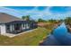 View of the canal-side property and screened-in pool at 8626 Agate St, Port Charlotte, FL 33981