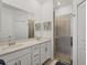 Double vanity bathroom with a walk-in shower at 8746 Saint Kitts Cir, Englewood, FL 34224