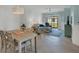 Light-filled dining room with seating for four and view of living room at 8746 Saint Kitts Cir, Englewood, FL 34224