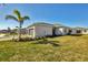 House exterior showcasing a landscaped yard and garage at 8746 Saint Kitts Cir, Englewood, FL 34224