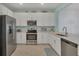 Bright kitchen featuring stainless steel appliances and white cabinets at 8746 Saint Kitts Cir, Englewood, FL 34224