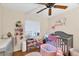 Bedroom with crib, changing table, and toys at 9000 Griggs Rd # G, Englewood, FL 34224